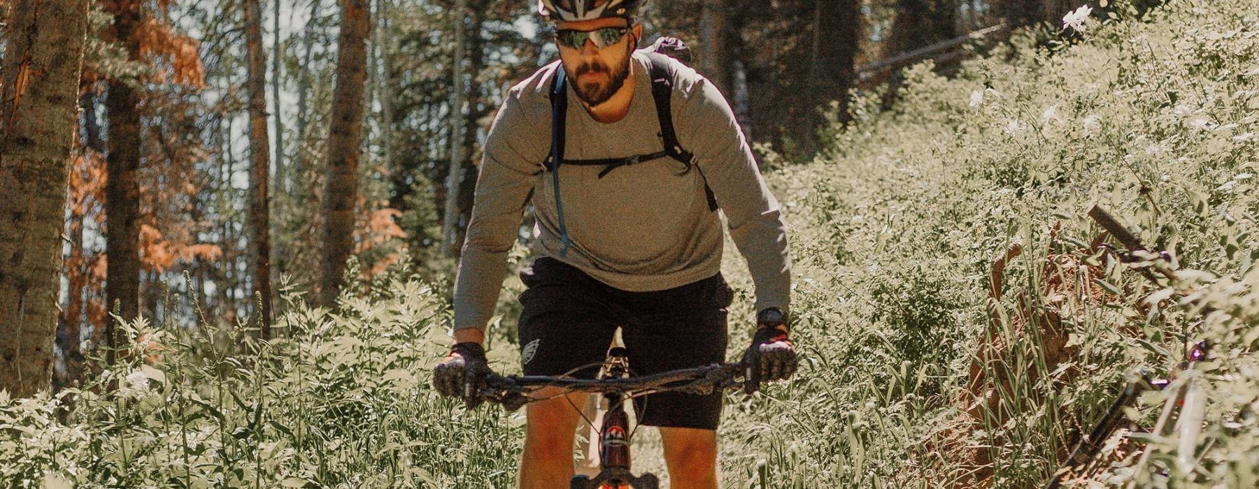 man riding a bike on a trail in the woods