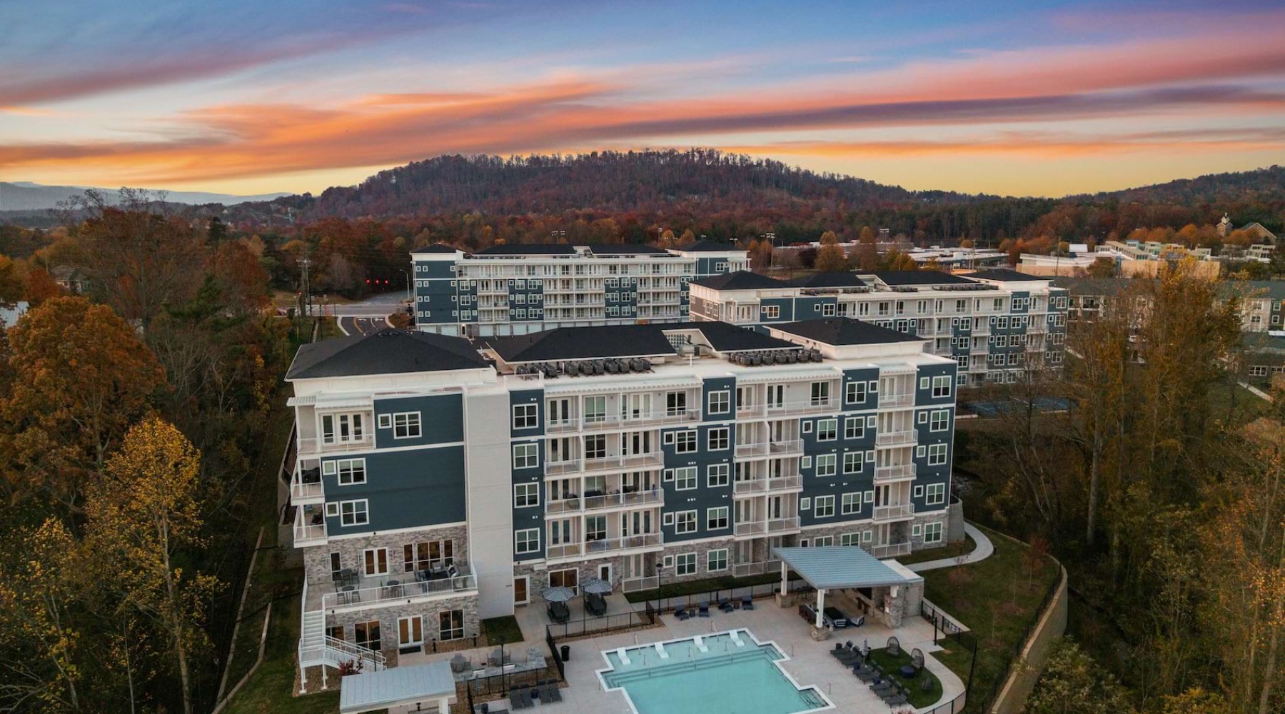 an aerial of a building and a pool