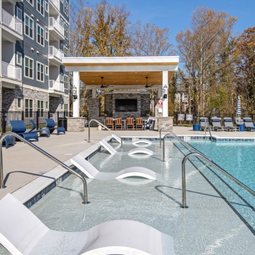 Resort-style swimming pool with lounge seating