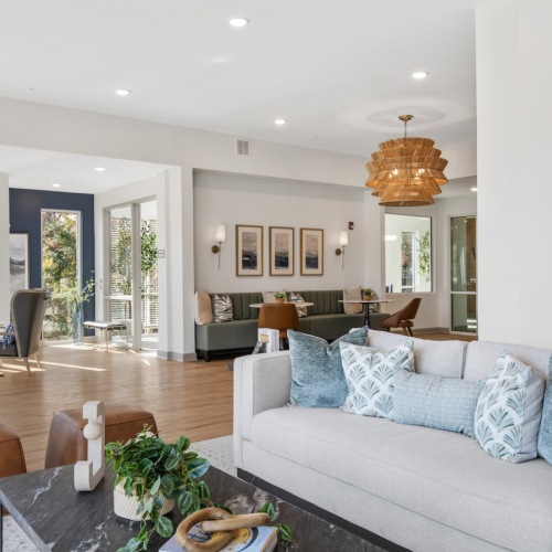 Beautiful clubroom with lounge seating and natural lighting and tables and chairs