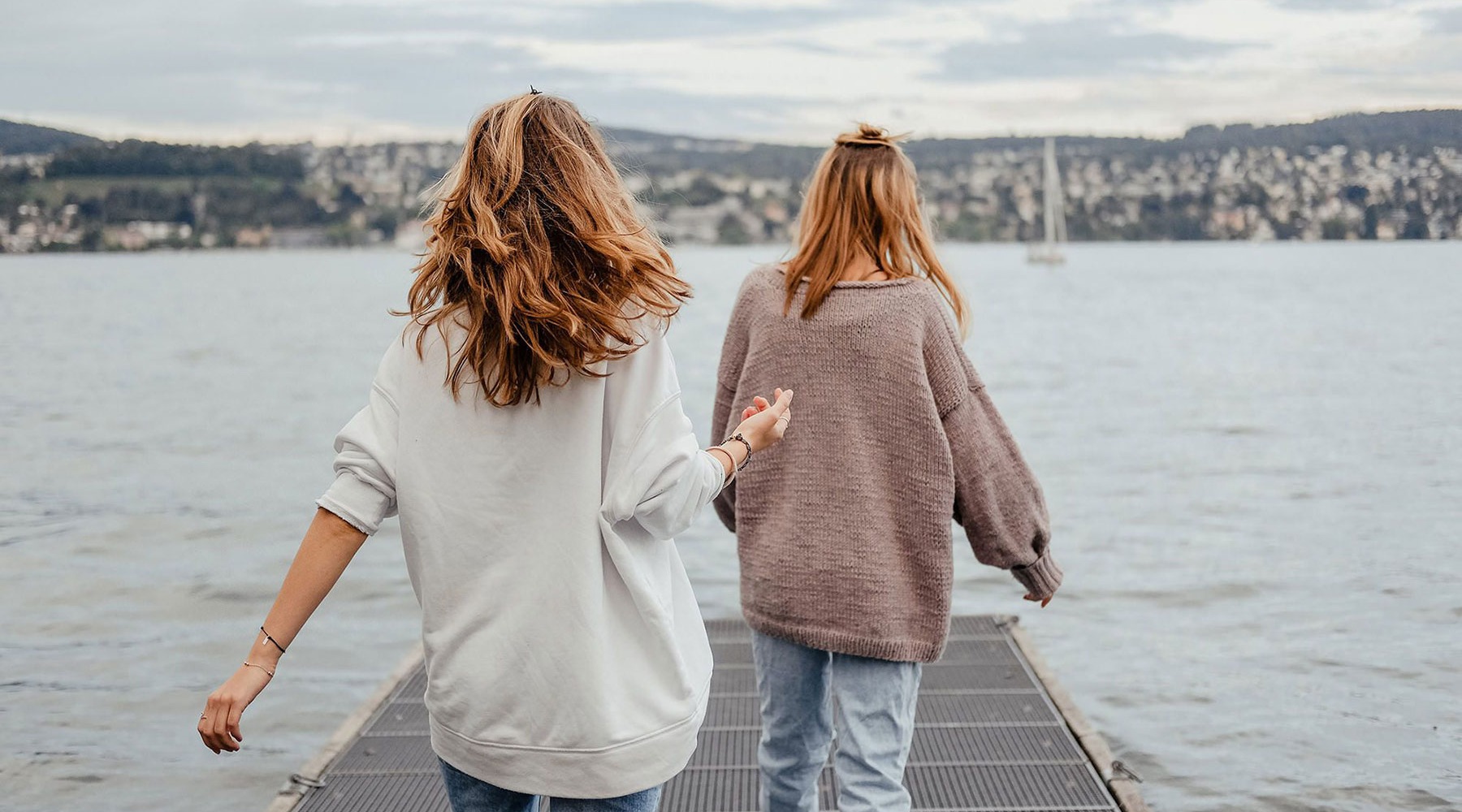 girls outdoors walking on pier